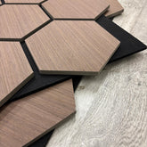 Hexagonal wooden tiles on a wooden surface