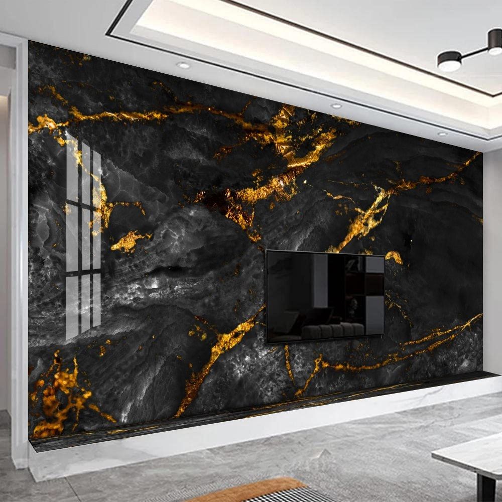 Modern living room with a black marble wall featuring gold veins and a television.