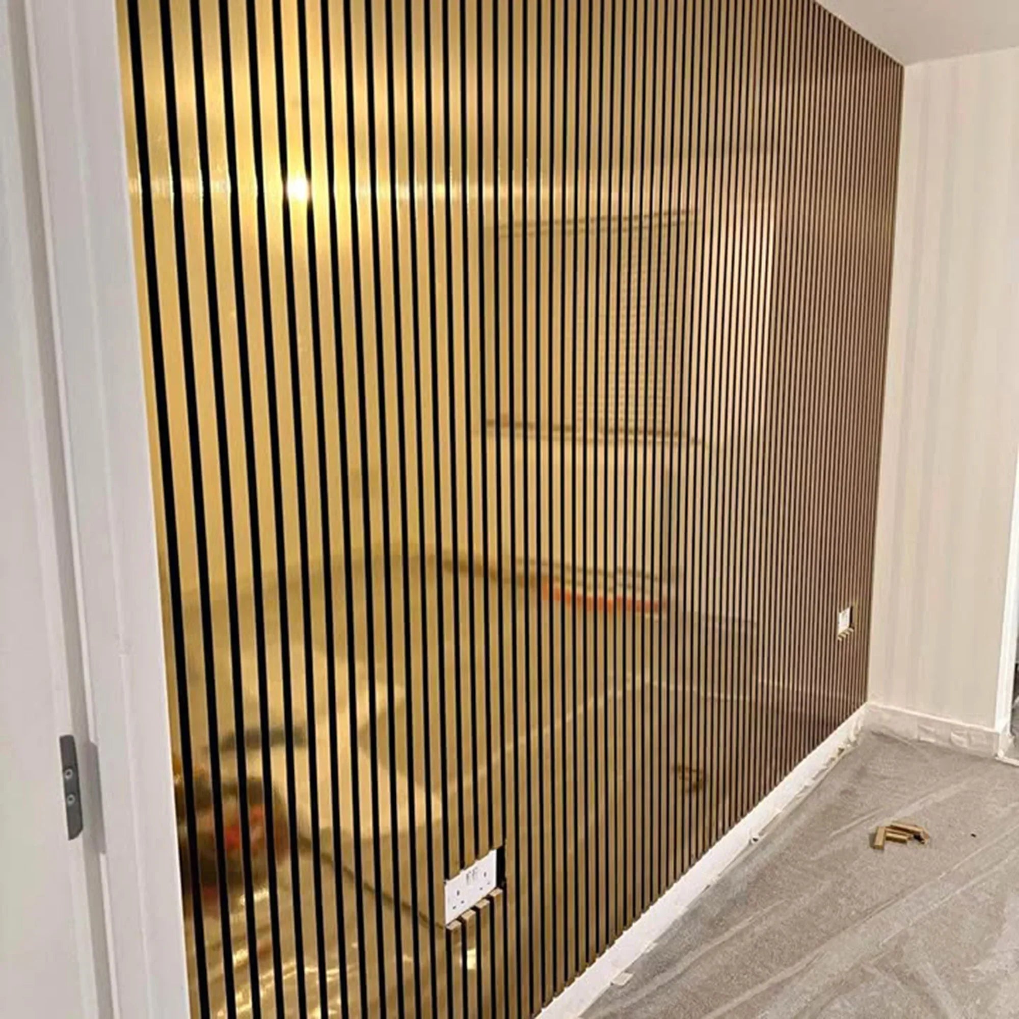 Gold vertical strip wall paneling in a room corner
